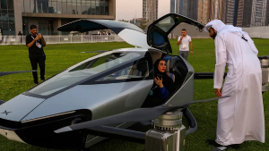 a woman sitting in a two seater flying car in Dubai